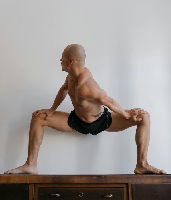 Athlete in a powerful yoga warrior pose, symbolizing strength and focus.